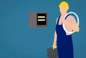 Travailleur réalisant une installation d’électricité générale.